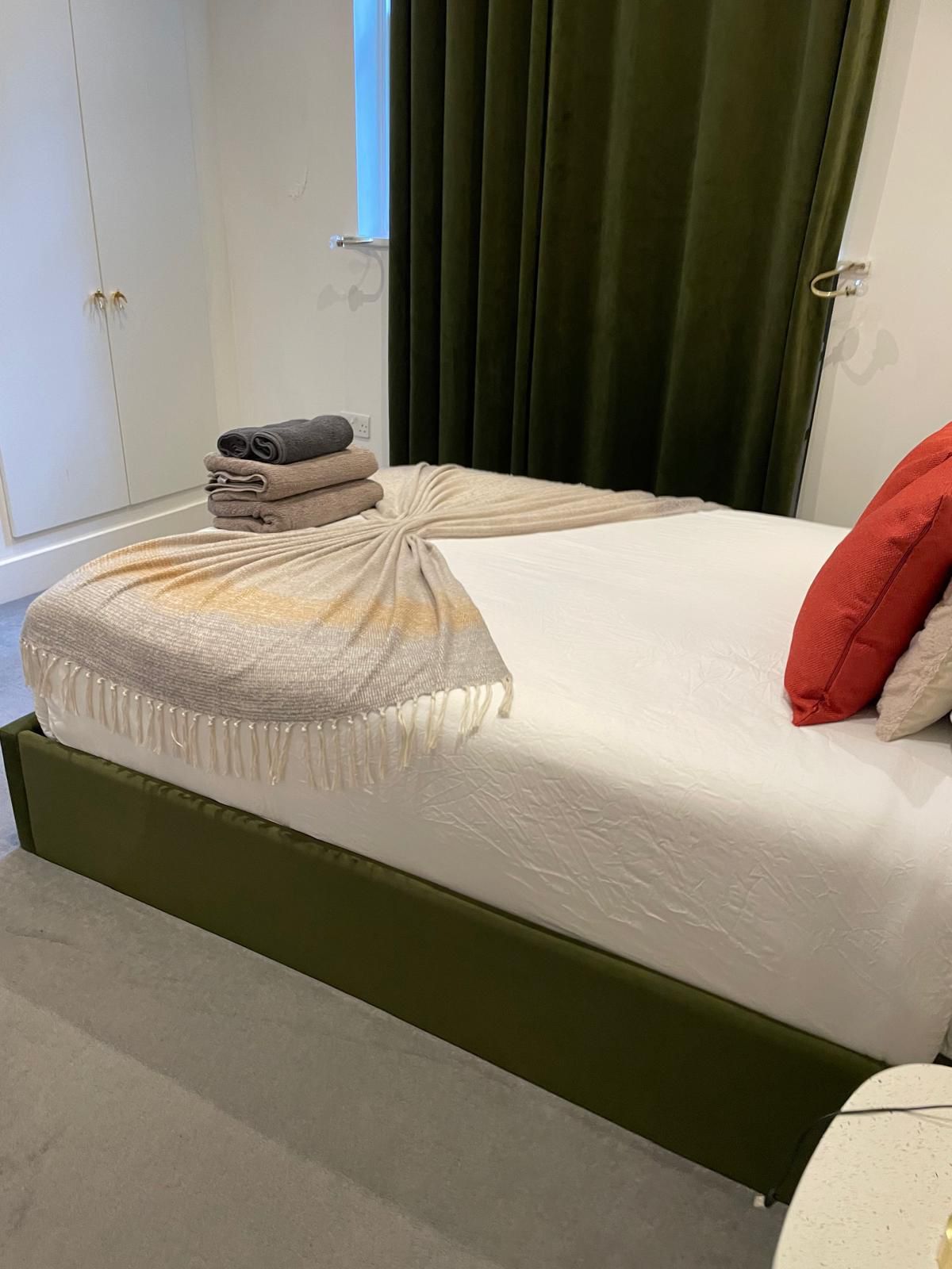 Made-up guest bed with towels
